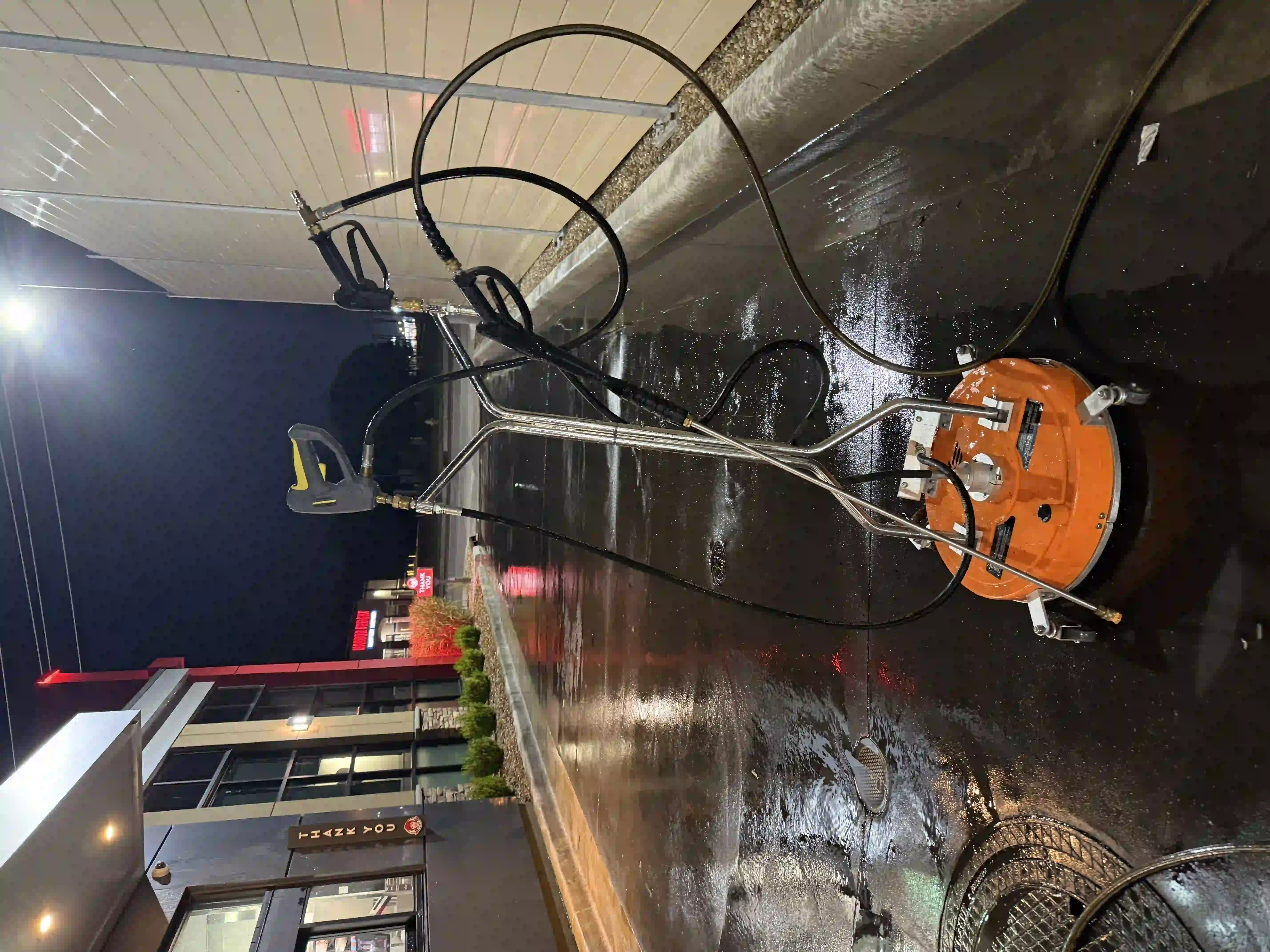 Okie Hustle power washing a residential driveway