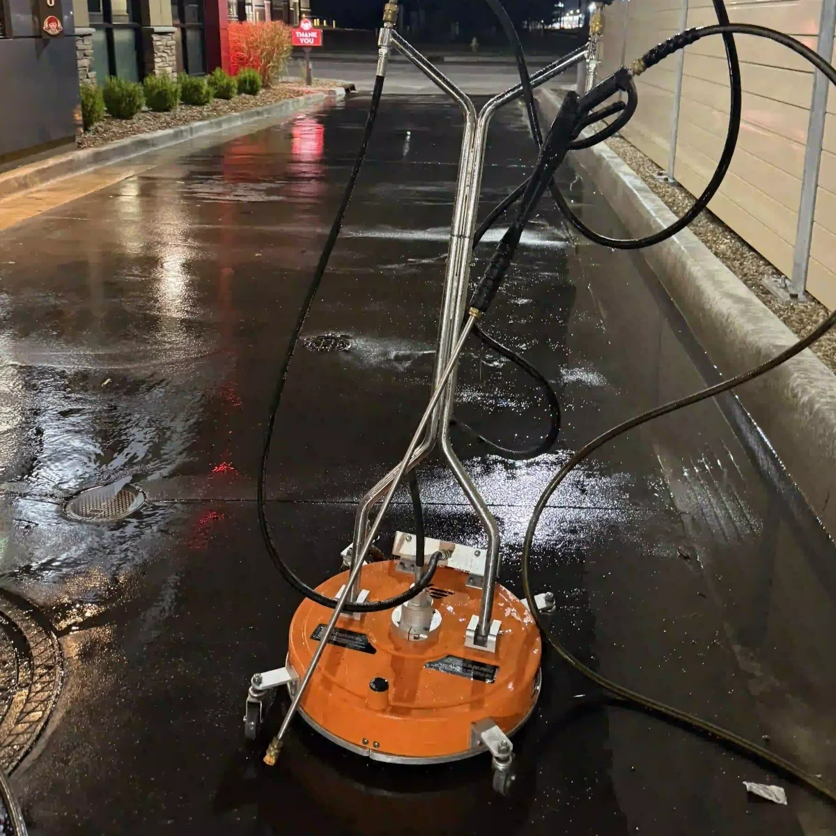Surface cleaner equipment on a freshly power-washed driveway